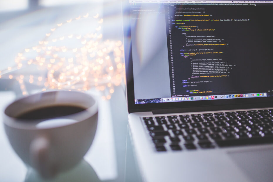 Computer with coffee, overlooking a city